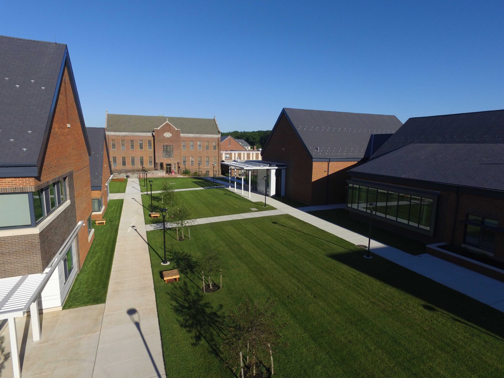 an aerial view of a grassy courtyard and buildings.