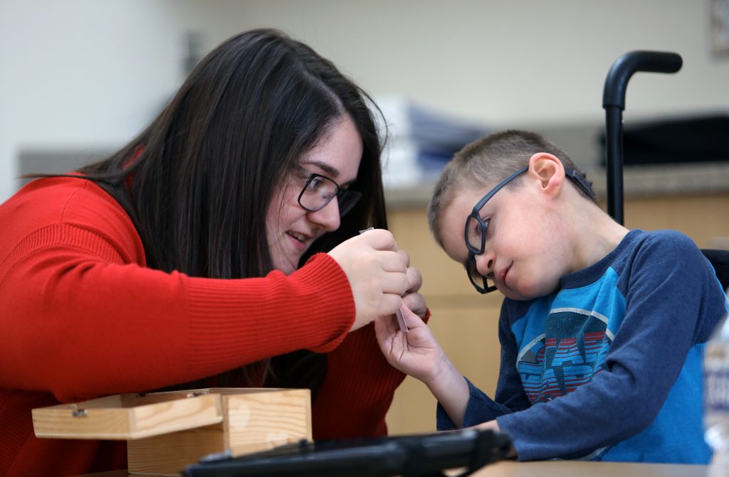 Instructor sharing tactile lesson with pre-k student.