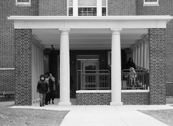 a couple of people that are standing in front of a building.