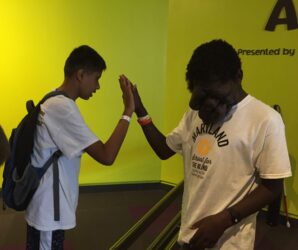 Two students giving a high five to one another