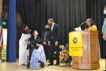 Student in wheelchair receiving her diploma