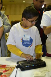 a young boy using a laptop computer at a table.