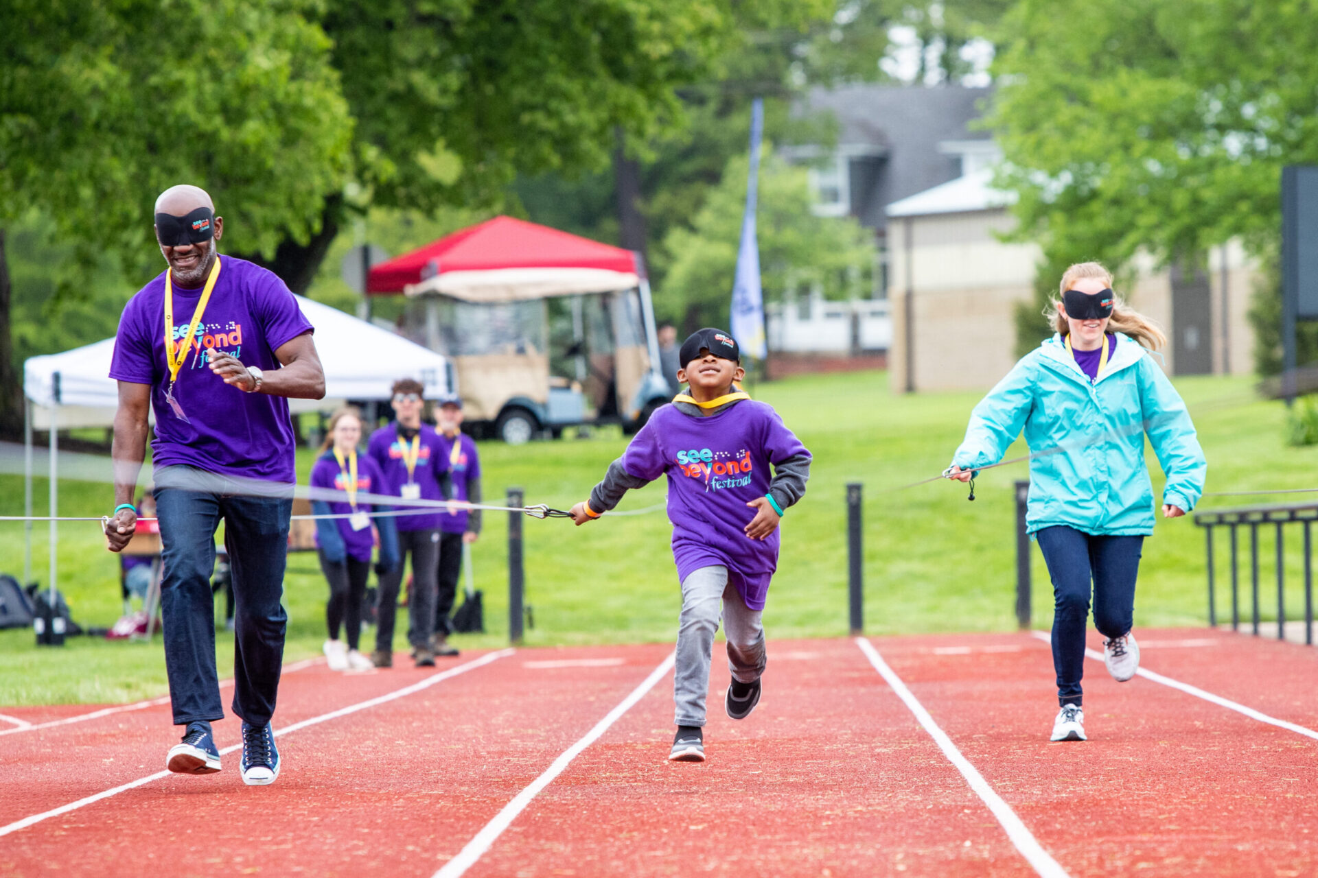 a group of people running on a track. a group of people running on a track.