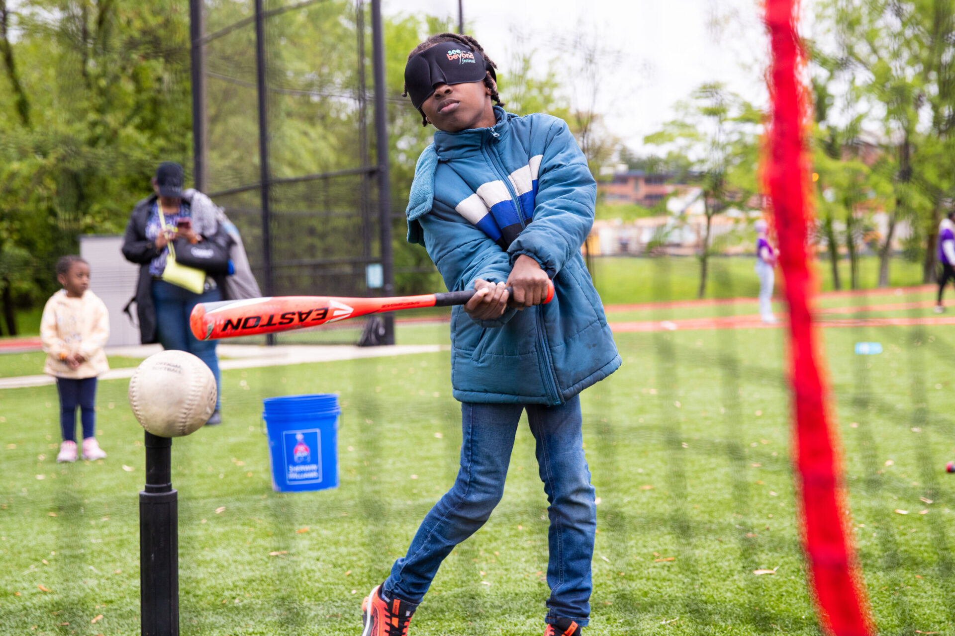 a man swinging a baseball bat at a ball. a man swinging a baseball bat at a ball.