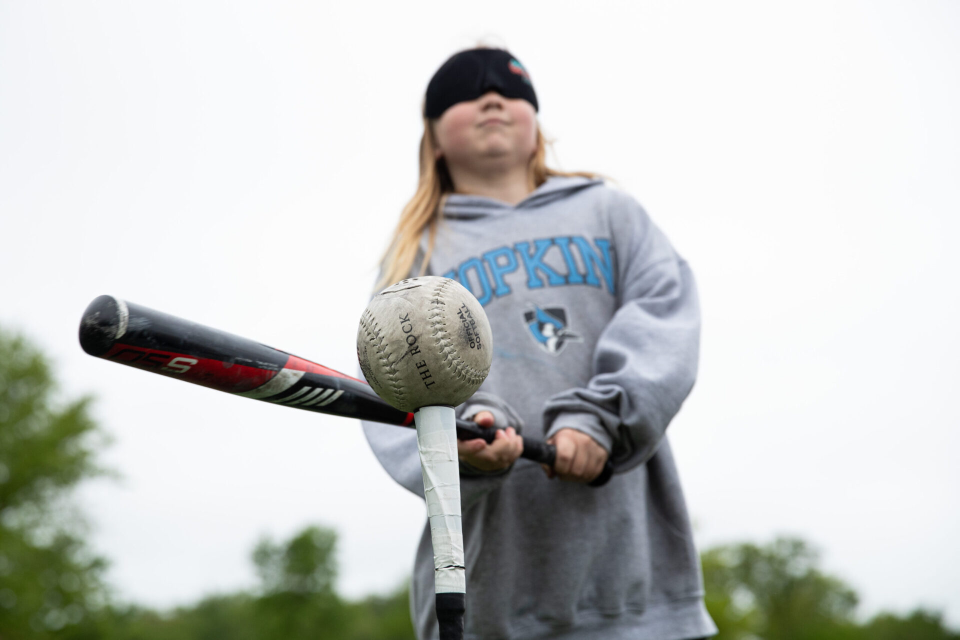 a young girl holding a baseball bat and ball. a young girl holding a baseball bat and ball.