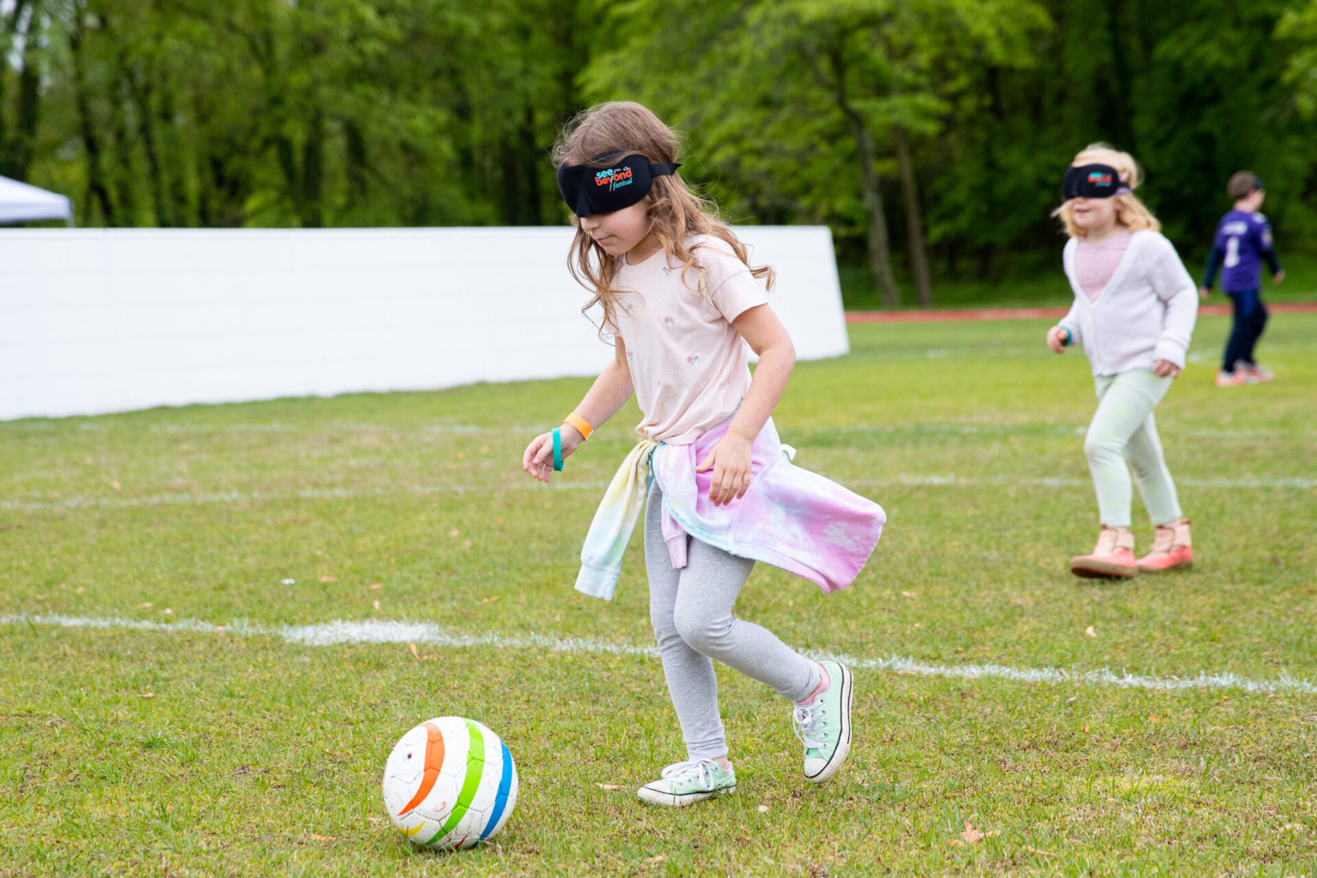 a group of young children playing a game of soccer. a group of young children playing a game of soccer.