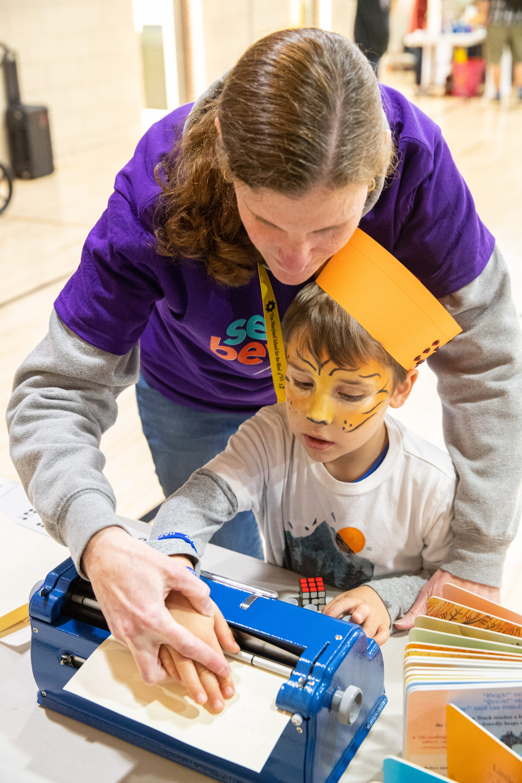 a woman and a child with face paint on. a woman and a child with face paint on.