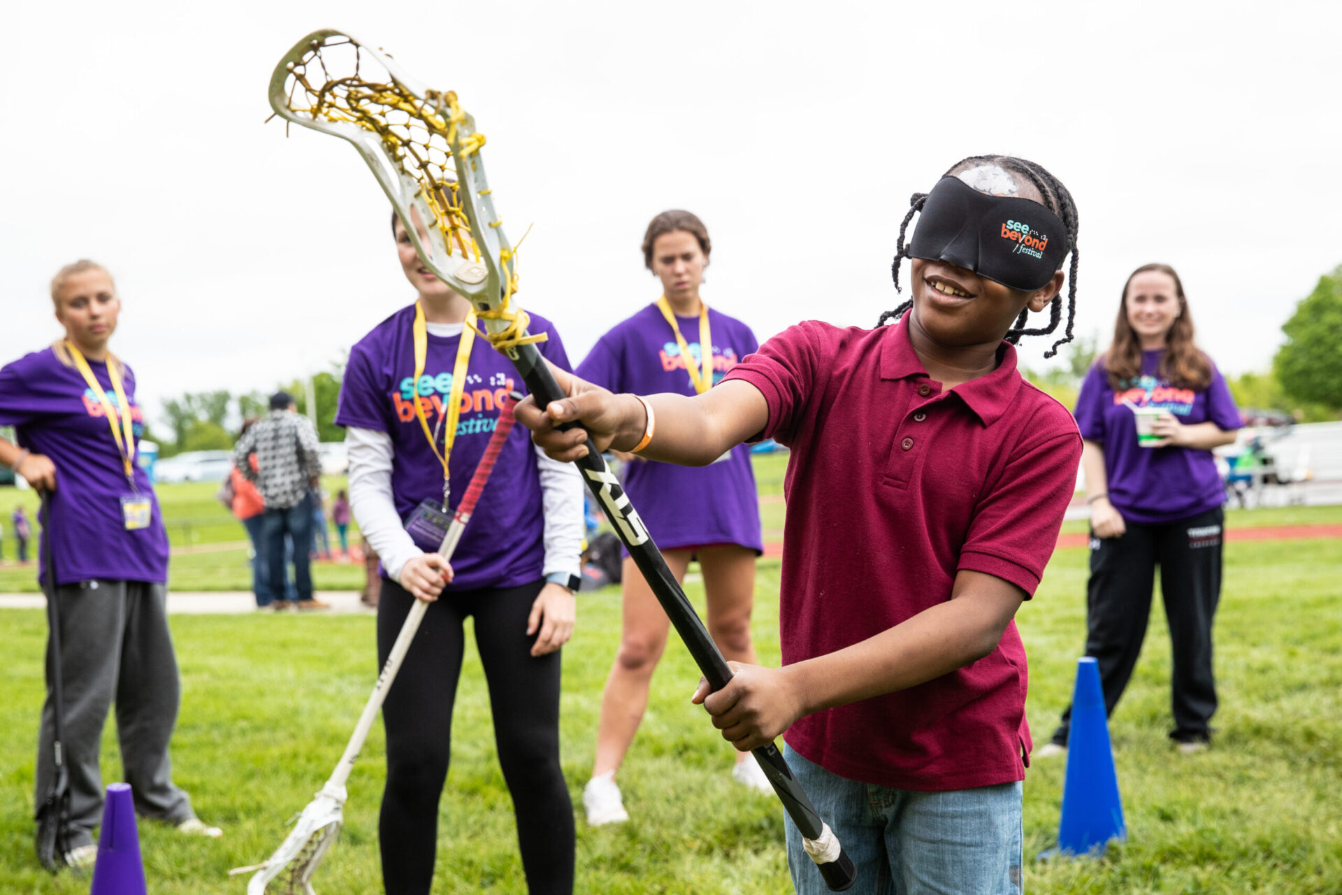 a group of young people playing a game of lacrosse. a group of young people playing a game of lacrosse.
