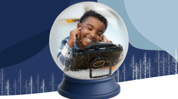 A smiling child wearing headphones uses a tablet, enclosed in a snow globe with falling snow, set against a blue, winter-themed background with white, minimalist tree silhouettes.